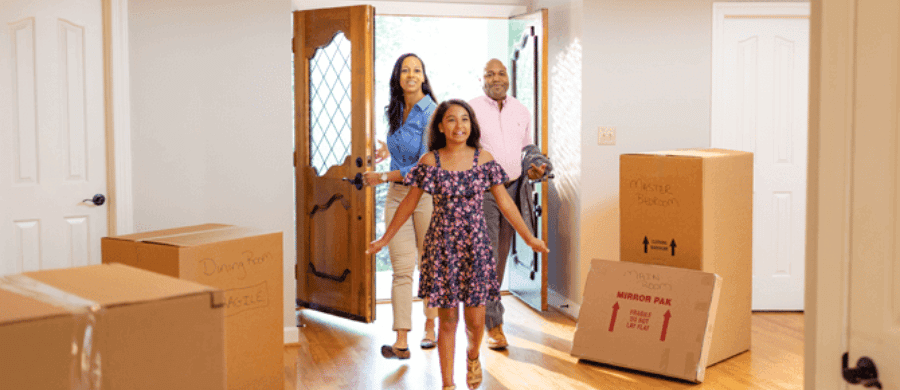 Young family of 3 walking into their new home