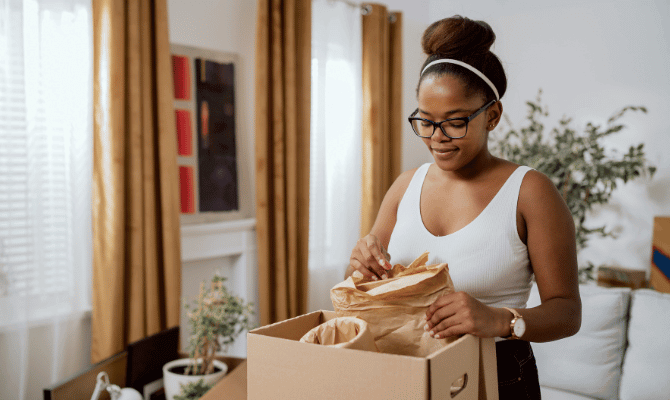 Young woman unpacking in her new home