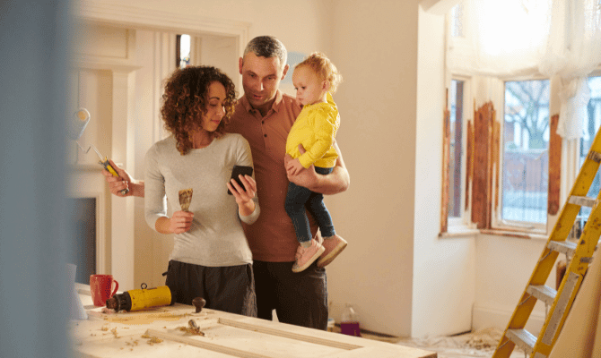 Young couple remodeling their home with their toddler