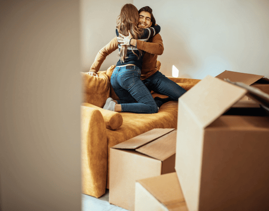 Young couple embracing while moving into new home