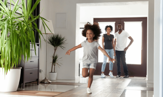 Family of 3 in the foyer of their luxury home