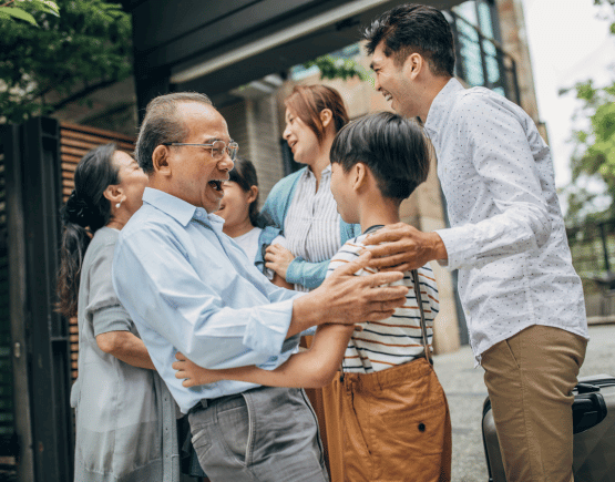 Family of 4 greeting their children's grandparents