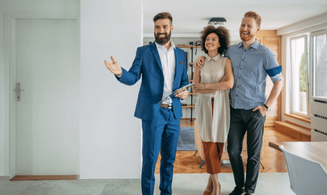 Realtor showing young couple a home for sale